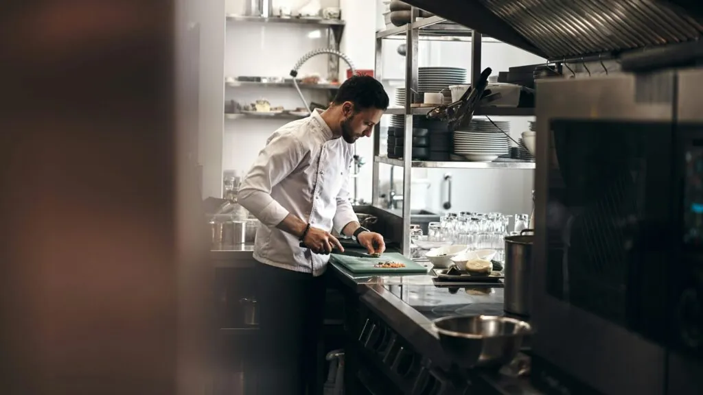 Chef looking at sales on tablet